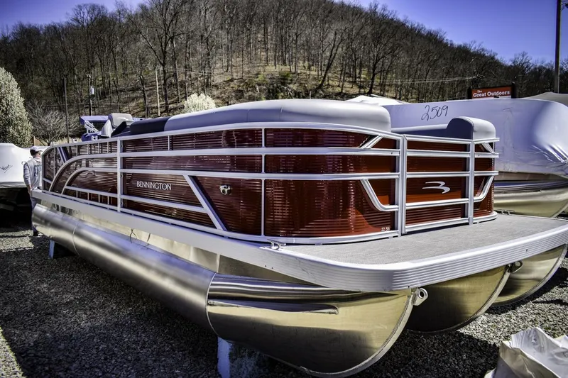 The Image of 2024 Bennington 22 SVSB pontoon boat parked outdoors, showcasing sleek design and modern features. - 1
