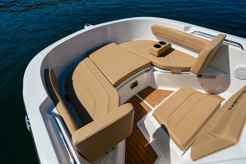 Slide: The Image of 2024 Bayliner Trophy 20CX boat interior with tan seating and cup holders. - 18