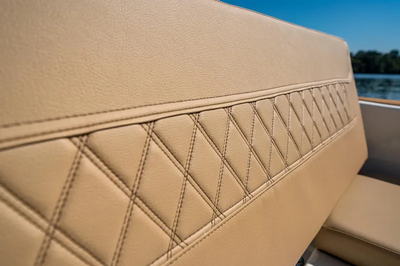 Slide: The Image of 2024 Bayliner Trophy 20CX boat seat with diamond-stitched tan upholstery. - 20