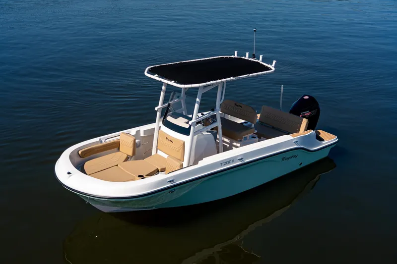 Slide: The Image of 2024 Bayliner Trophy 20CX boat on calm water, featuring sleek design and spacious deck. - 23