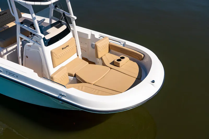 Slide: The Image of 2024 Bayliner Trophy 20CX boat with tan seating and cup holders on calm water. - 31