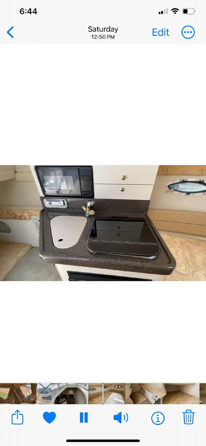 Slide: The Image of 2001 Larson 254 Cabrio boat kitchenette with sink and stove. - 5