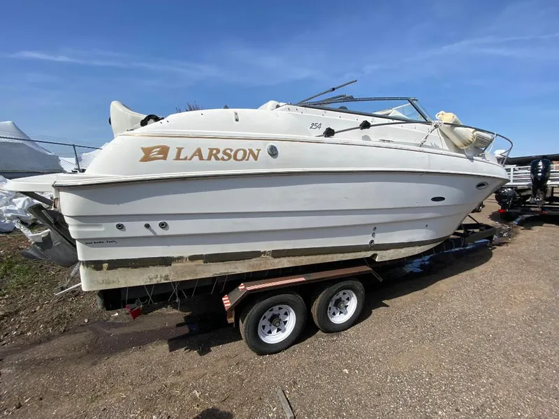 Slide: The Image of 2001 Larson 254 Cabrio boat on trailer under clear blue sky. - 8