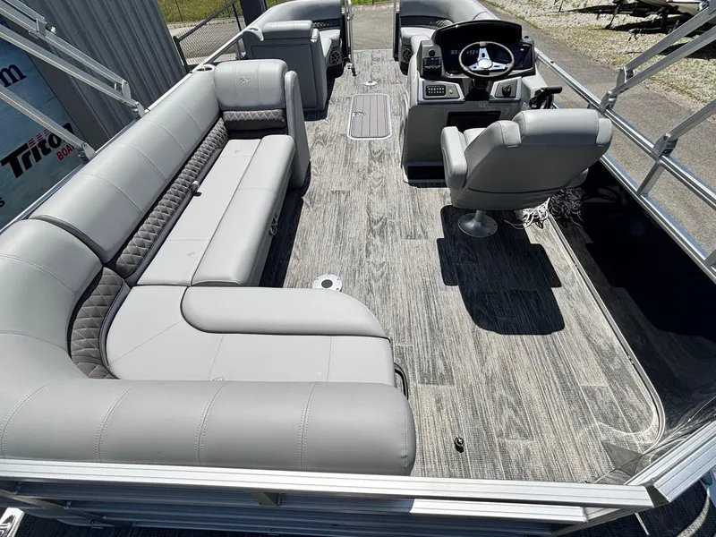 Slide: The Image of 2025 Ranger Reata 223C pontoon boat interior with gray seating and modern helm. - 10