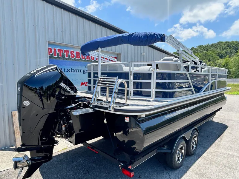 Slide: The Image of 2025 Ranger Reata 223C pontoon boat with Mercury engine, parked outdoors. - 12
