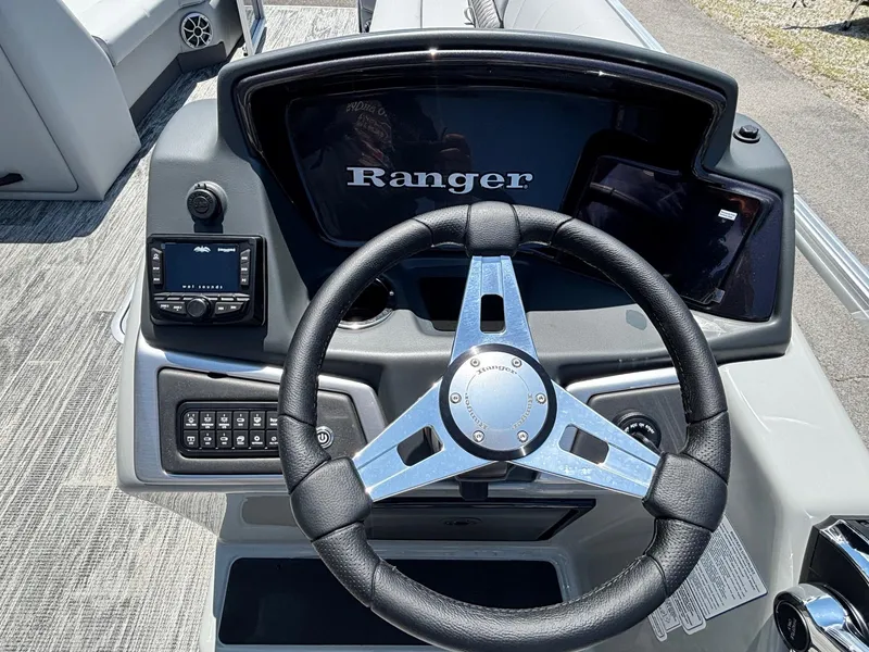 Slide: The Image of Steering console of 2025 Ranger Reata 223C boat with modern controls and display. - 8
