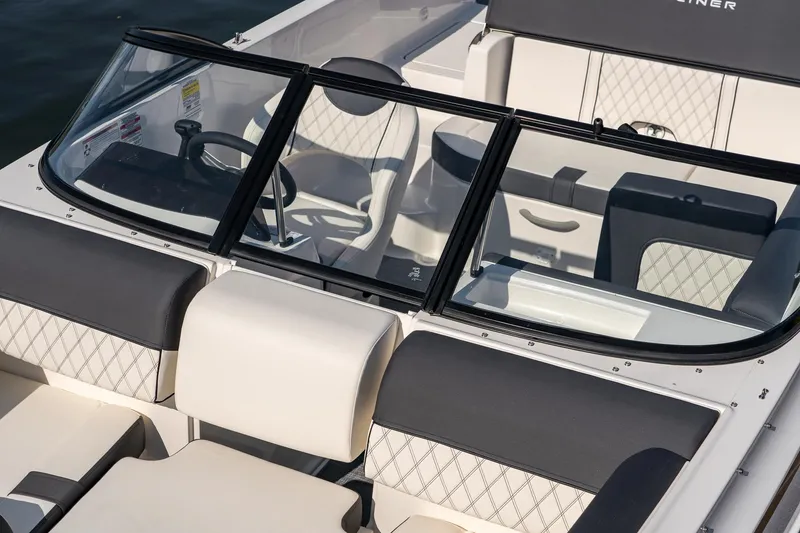 Slide: The Image of 2023 Bayliner DX2000 boat interior with modern seating and steering wheel. - 13