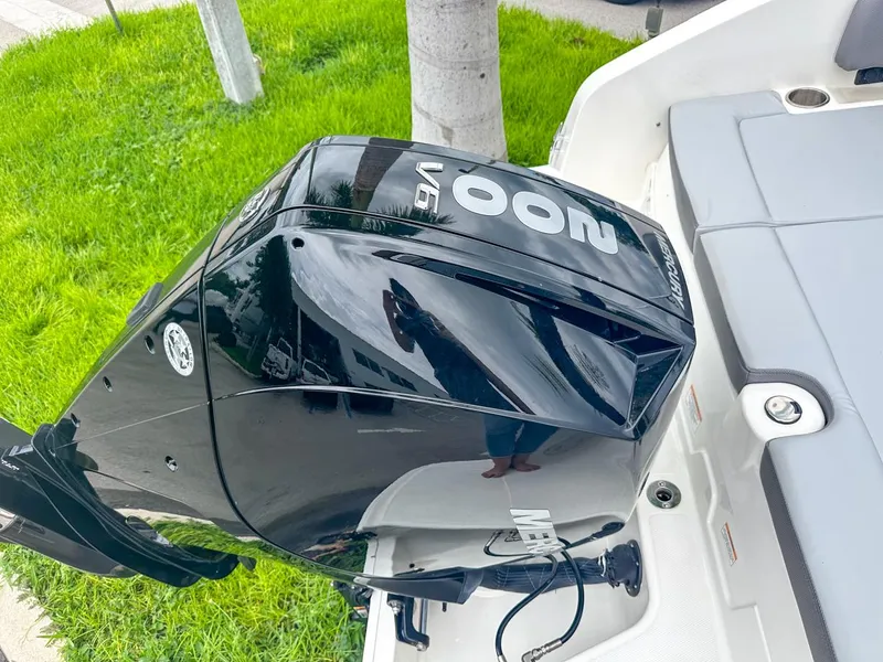 Slide: The Image of 2024 Bayliner DX2200 boat with powerful black outboard motor. - 10