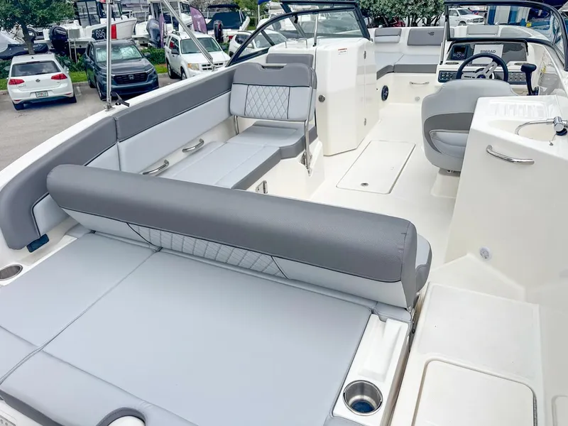 Slide: The Image of 2024 Bayliner DX2200 boat interior with gray seating and modern design. - 11