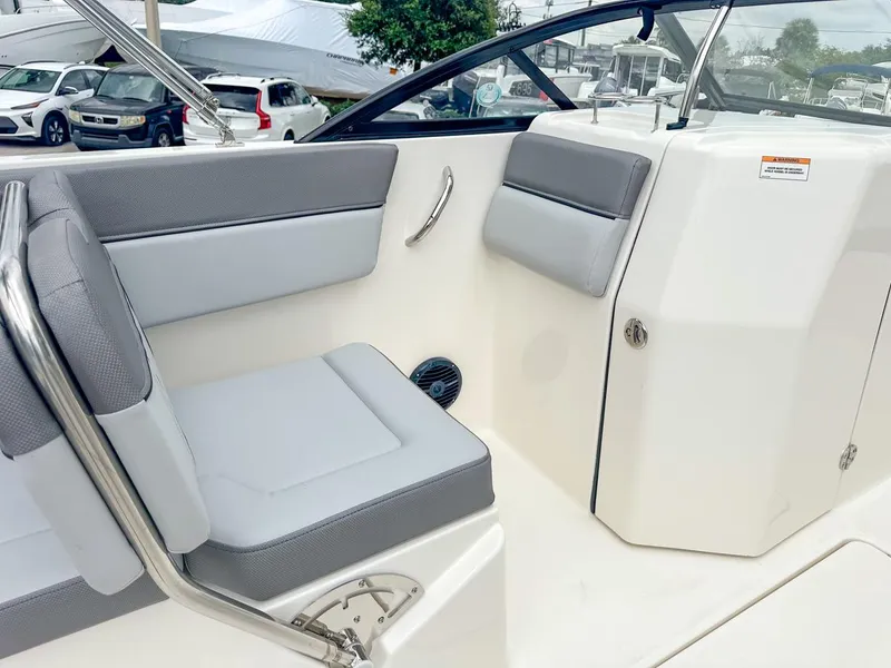 Slide: The Image of 2024 Bayliner DX2200 boat interior with gray seating and sleek design. - 17