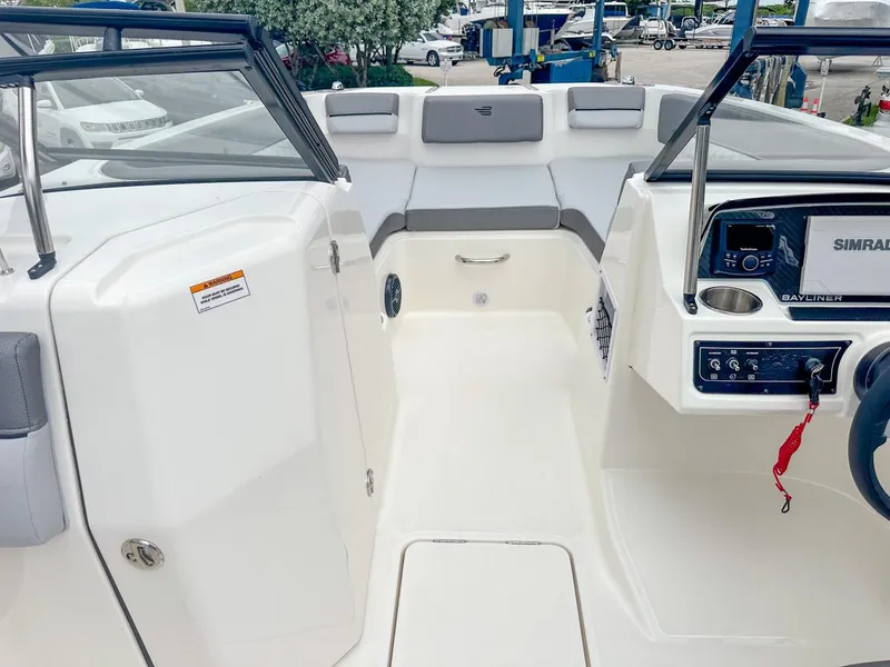 Slide: The Image of 2024 Bayliner DX2200 boat interior with seating and control panel. - 19