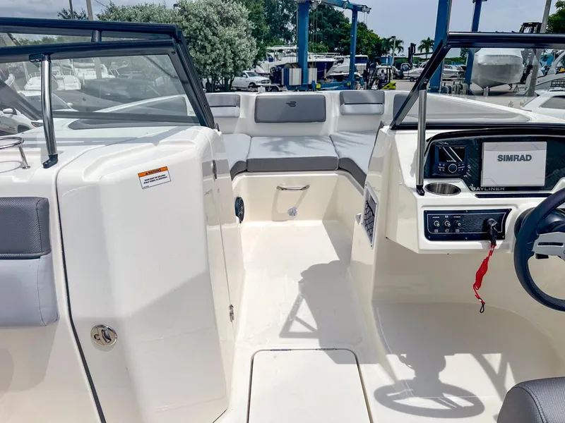 Slide: The Image of 2024 Bayliner DX2200 boat interior with seating and navigation system. - 27