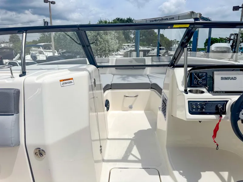 Slide: The Image of 2024 Bayliner DX2200 boat interior with modern dashboard and seating. - 28