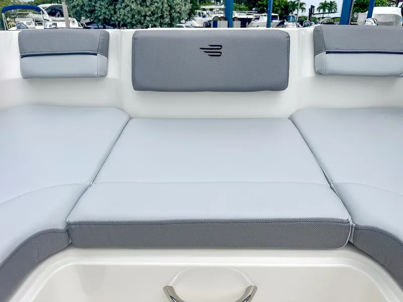 Slide: The Image of 2024 Bayliner DX2200 boat interior with gray cushioned seating. - 30