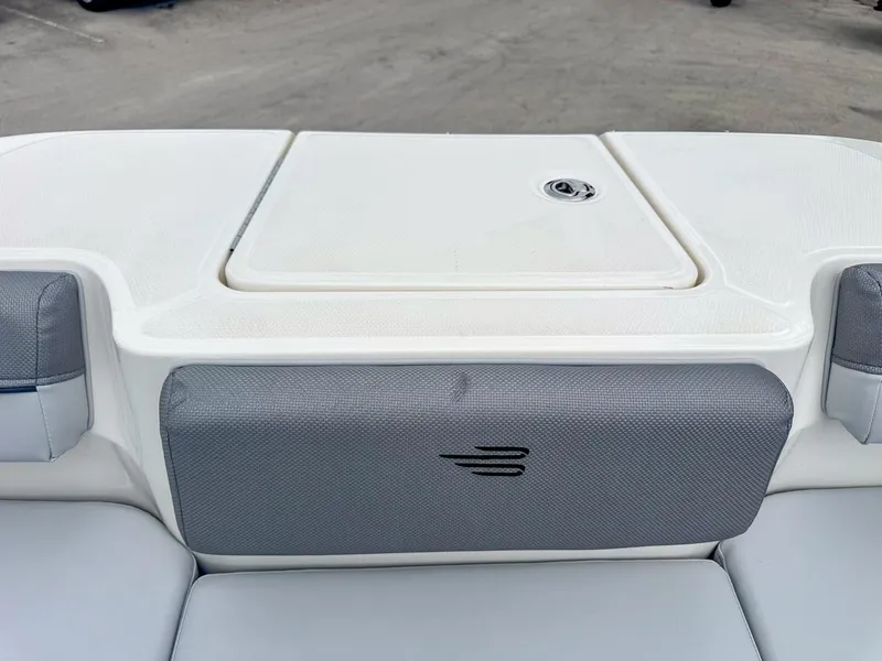 Slide: The Image of 2024 Bayliner DX2200 boat interior with gray and white seating and storage compartment. - 31