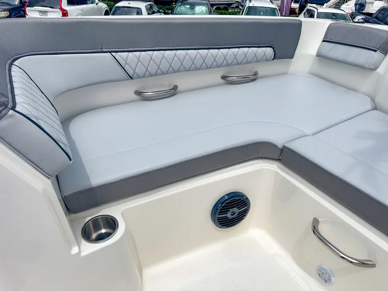 Slide: The Image of 2024 Bayliner DX2200 boat interior with cushioned seating and stainless steel accents. - 33