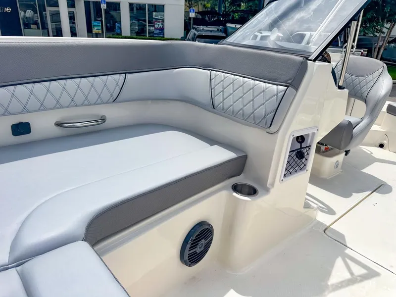 Slide: The Image of 2024 Bayliner DX2200 boat interior with cushioned seating and modern design. - 35