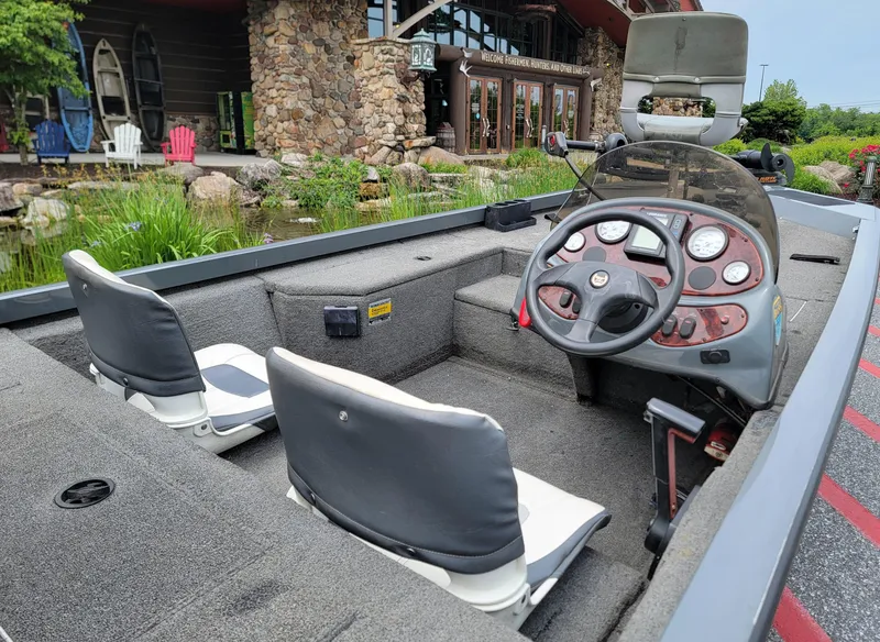 Slide: The Image of 2002 Triton 175 Sport boat interior with steering wheel and two seats. - 3