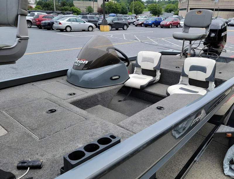 Slide: The Image of 2002 Triton 175 Sport boat with seating, parked in a lot. - 5