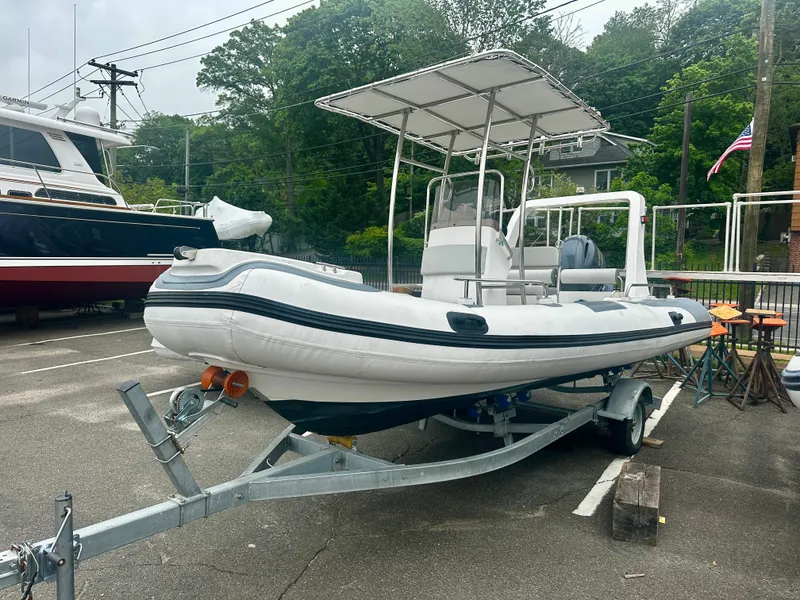 The Image of 2021 Hedia Rib580 boat on trailer in a parking lot. - 1