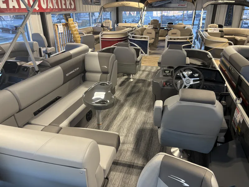 Slide: The Image of 2025 Bennington 21 SF pontoon boat interior with gray seating and modern dashboard. - 2