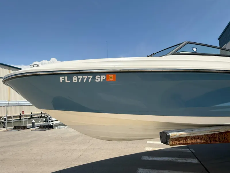 Slide: The Image of 2020 Sea Ray SPX 230 OB boat, blue hull, docked, registration FL 8777 SP. - 11