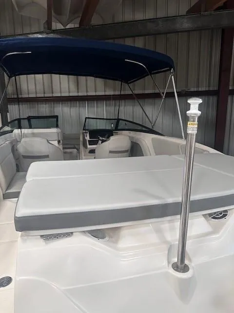 Slide: The Image of 2020 Sea Ray SPX 230 OB boat with seating and canopy in storage. - 14