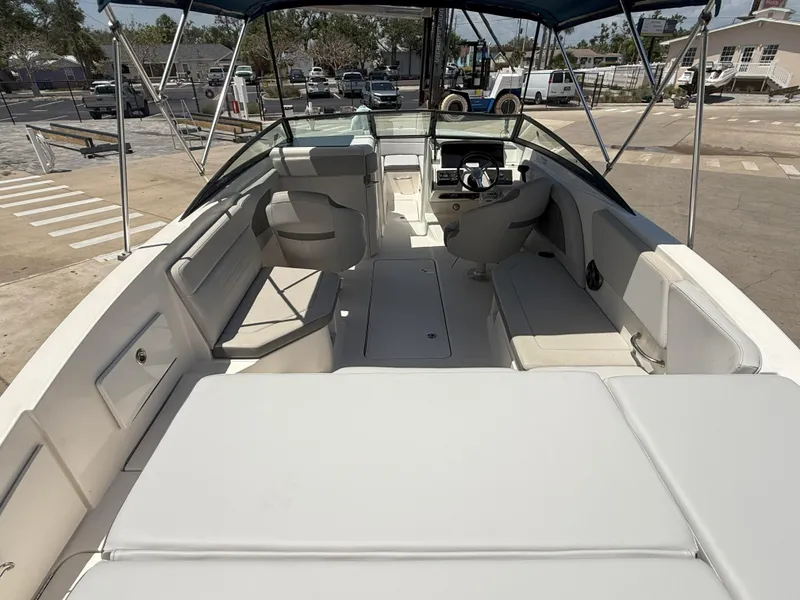 Slide: The Image of 2020 Sea Ray SPX 230 OB boat interior with seating and steering wheel. - 15