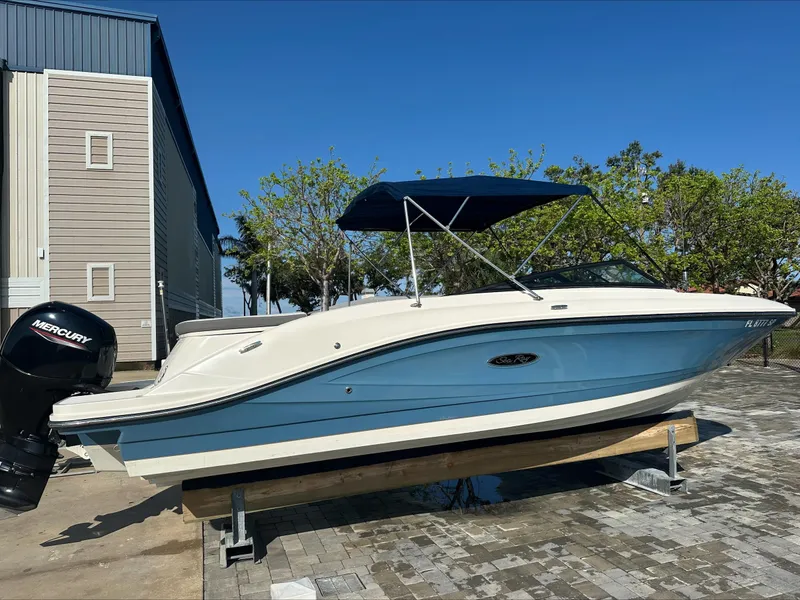 Slide: The Image of 2020 Sea Ray SPX 230 OB boat with blue hull and Mercury outboard motor. - 2