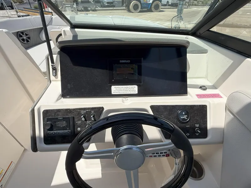Slide: The Image of 2020 Sea Ray SPX 230 OB boat dashboard with steering wheel and control panel. - 20