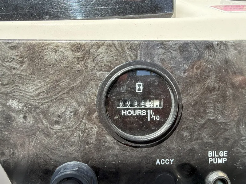 Slide: The Image of Hour meter on 2020 Sea Ray SPX 230 OB boat dashboard, showing 99.5 hours. - 22