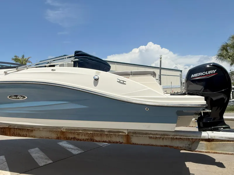 Slide: The Image of 2020 Sea Ray SPX 230 OB boat with Mercury outboard motor, docked under a clear sky. - 8