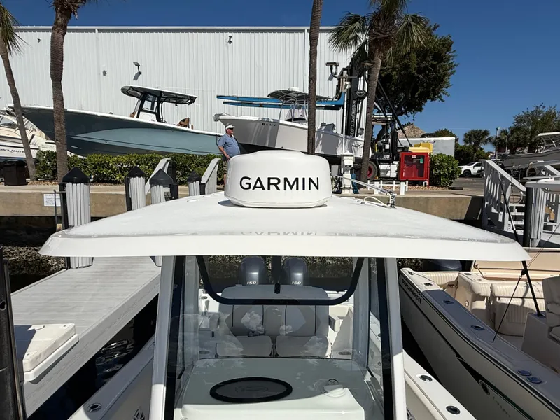 Slide: The Image of 2023 Sea Hunt Gamefish 25 with Garmin equipment at a marina dock. - 11