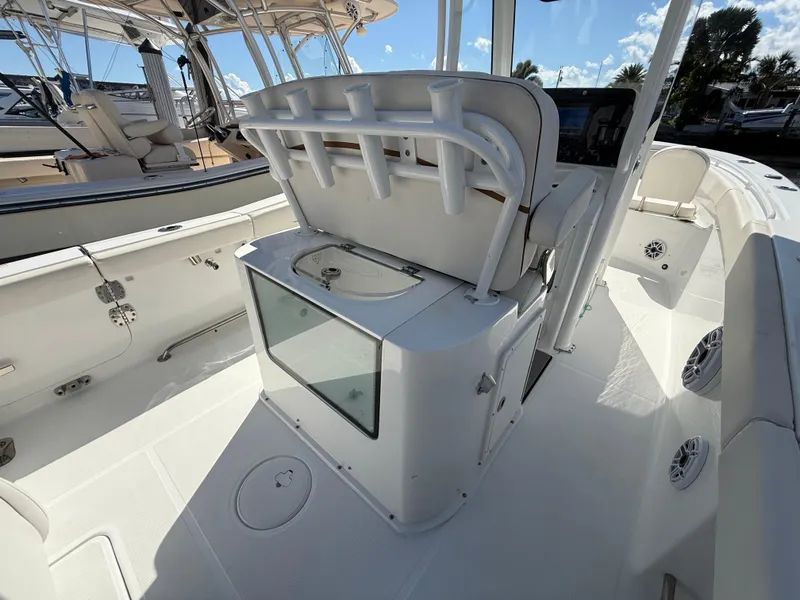 Slide: The Image of 2023 Sea Hunt Gamefish 25 boat interior with rod holders and storage. - 12