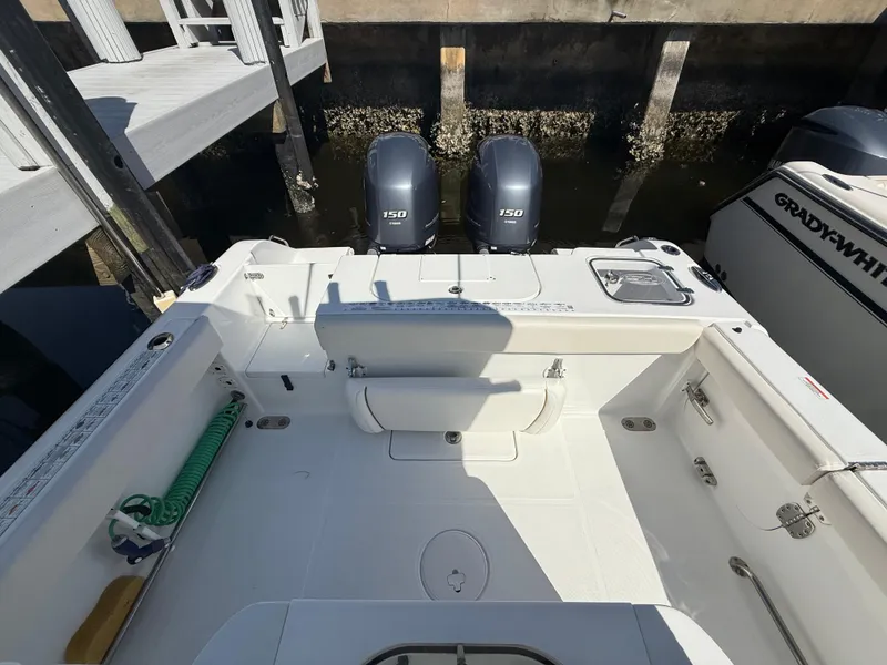 Slide: The Image of 2023 Sea Hunt Gamefish 25 boat with dual 150 engines docked at marina. - 19