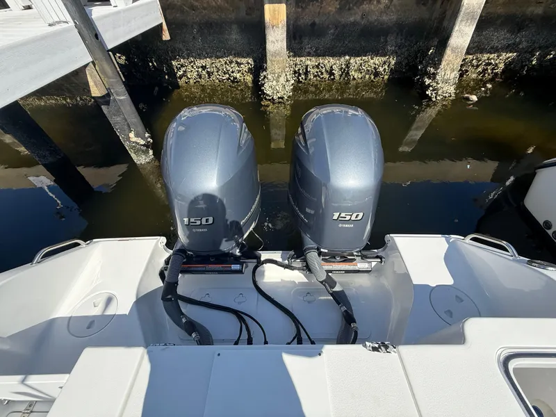 Slide: The Image of 2023 Sea Hunt Gamefish 25 with twin 150 horsepower engines docked at marina. - 21