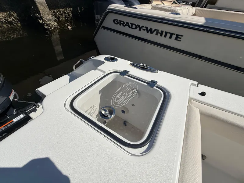 Slide: The Image of 2023 Sea Hunt Gamefish 25 boat with Grady-White branding, featuring a sleek deck design. - 23