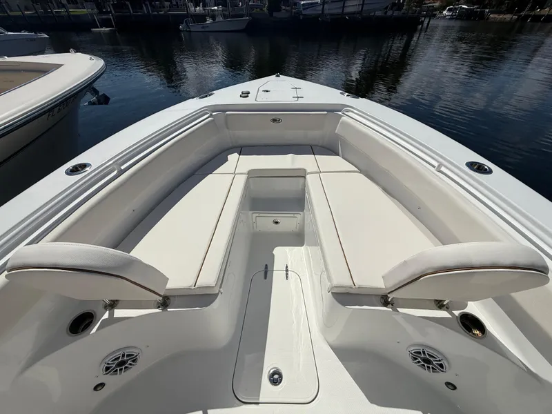 Slide: The Image of 2023 Sea Hunt Gamefish 25 boat interior with cushioned seating and storage. - 25