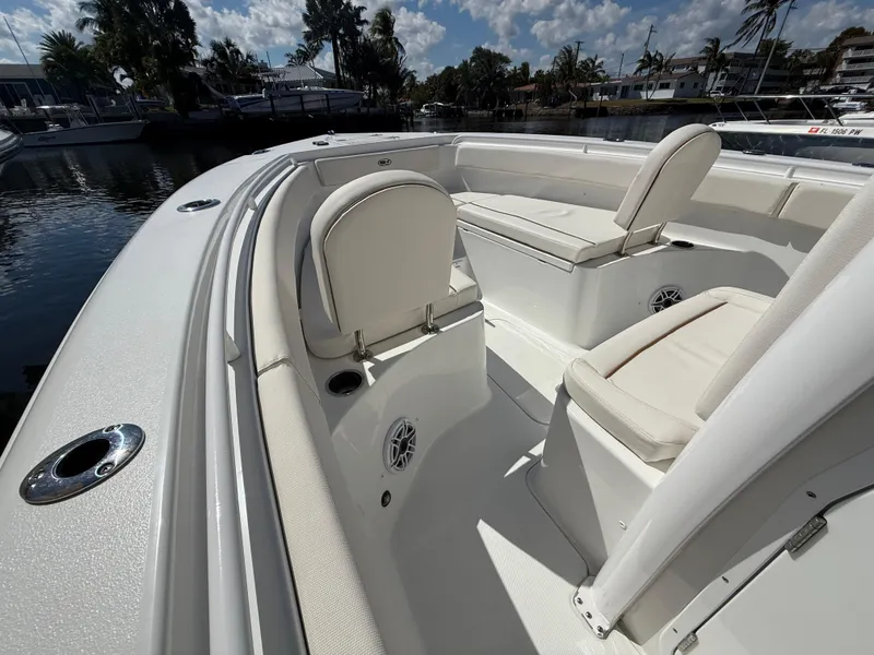 Slide: The Image of 2023 Sea Hunt Gamefish 25 boat interior with cushioned seating and cup holders. - 29