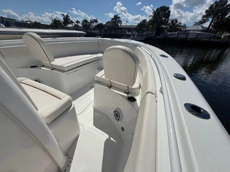 Slide: The Image of 2023 Sea Hunt Gamefish 25 boat interior with white seating and cup holders. - 30