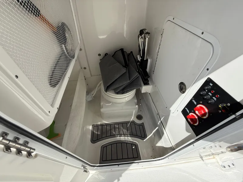 Slide: The Image of 2023 Sea Hunt Gamefish 25 boat interior with toilet and control panel. - 33
