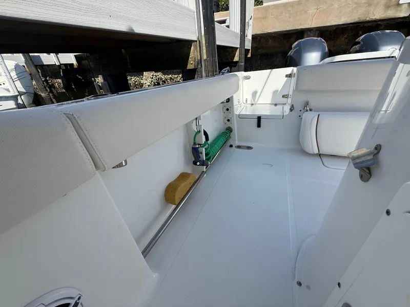 Slide: The Image of 2023 Sea Hunt Gamefish 25 boat interior with clean white deck and seating. - 37