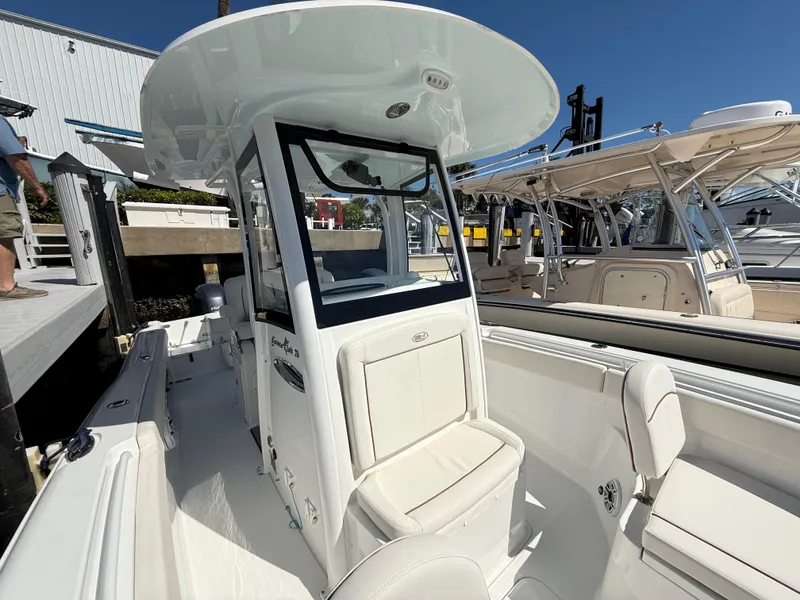 Slide: The Image of 2023 Sea Hunt Gamefish 25 boat with center console and seating, docked at marina. - 8