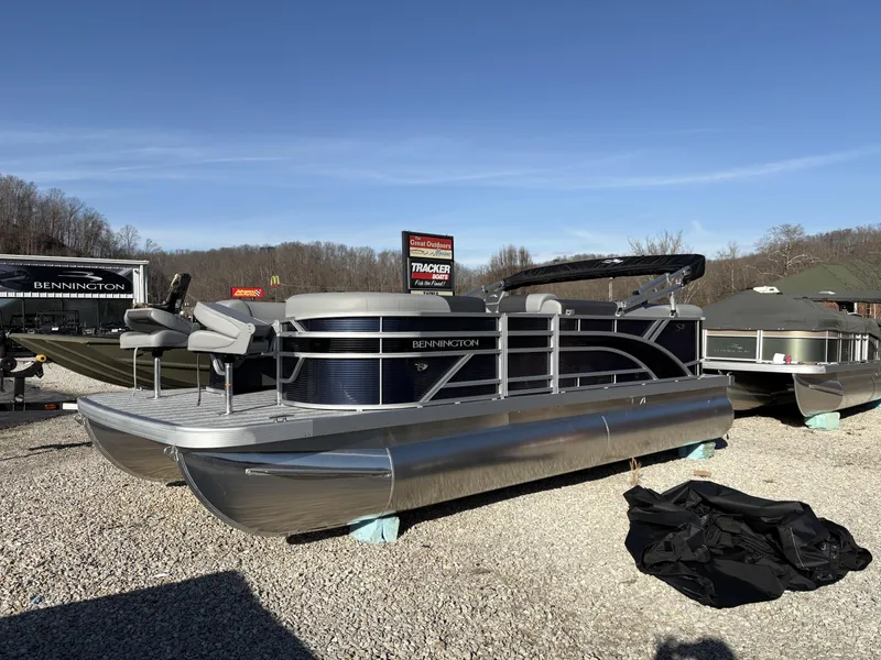 The Image of 2025 Bennington 21 SLBF pontoon boat displayed outdoors on gravel. - 1