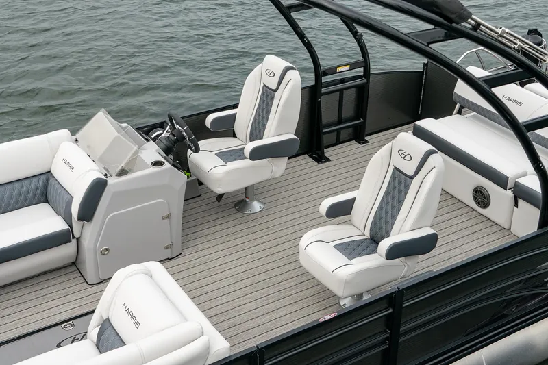 Slide: The Image of 2023 Harris 250 Sunliner Sport pontoon boat interior with luxury seating and helm. - 12