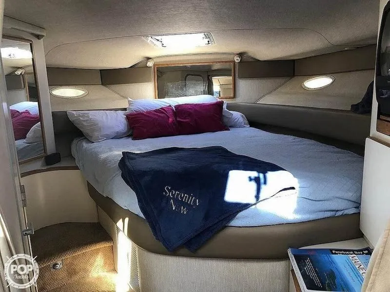 Slide: The Image of Interior of 1994 Sea Ray 370 Express Cruiser with plush seating and striped cushions. - 5