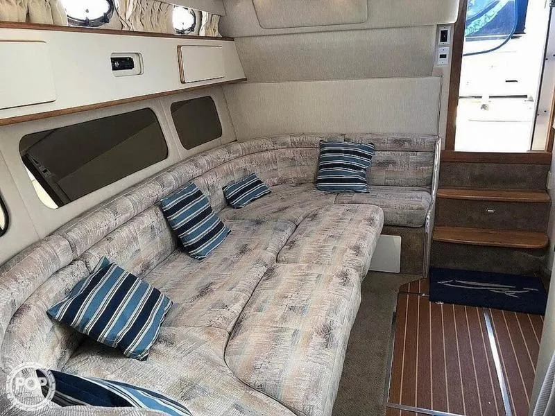 Slide: The Image of Interior of 1994 Sea Ray 370 Express Cruiser with TV, kitchenette, and stairs. - 6