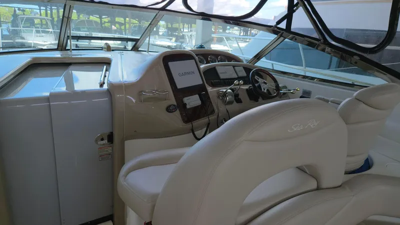 Slide: The Image of 2004 Sea Ray 380 Sundancer helm with steering wheel and navigation equipment. - 10