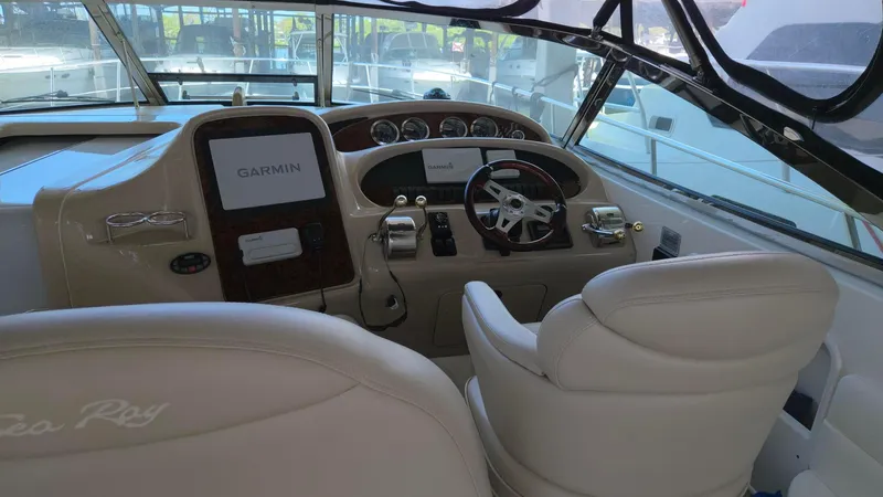 Slide: The Image of 2004 Sea Ray 380 Sundancer helm with Garmin navigation system and leather seating. - 11