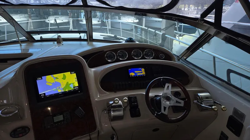 Slide: The Image of Helm of 2004 Sea Ray 380 Sundancer with navigation screens and controls. - 13